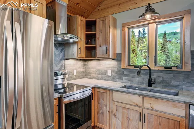 a kitchen with stainless steel appliances a refrigerator and a sink