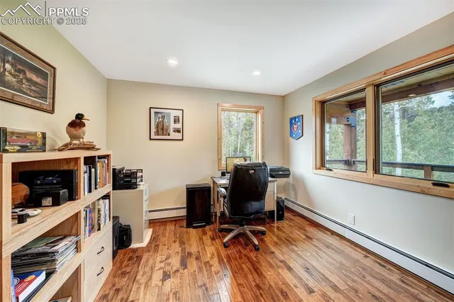 a view of a workspace with furniture and a window