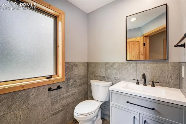 a bathroom with a sink a toilet and mirror