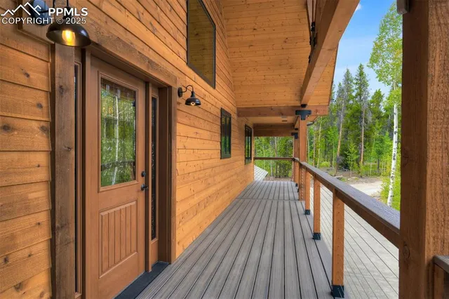 a view of a balcony with wooden floor and iron stairs