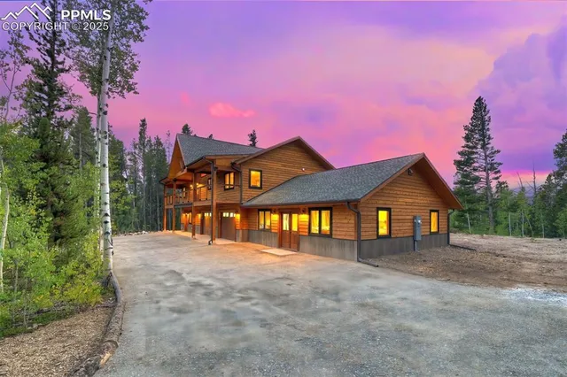 a front view of a house with a yard and lake view