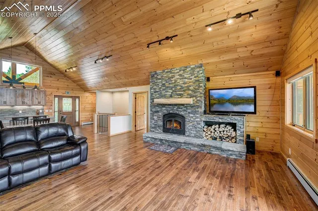 a living room with furniture a flat screen tv and a fireplace