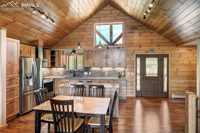 a large kitchen with a table and chairs