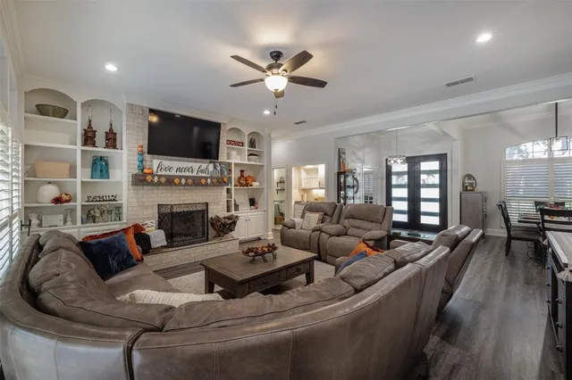 a living room with furniture fireplace and a flat screen tv