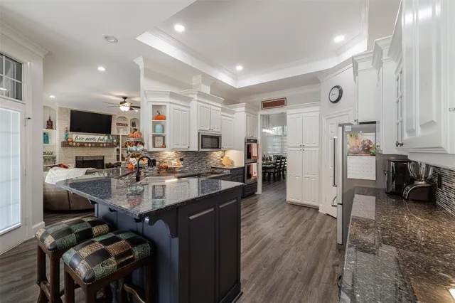 a kitchen with cabinets and chairs