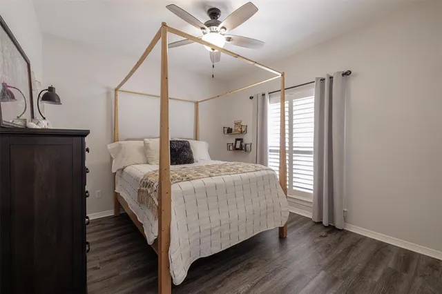 a bedroom with a bed and a ceiling fan