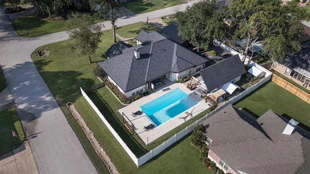 an aerial view of a house with a yard