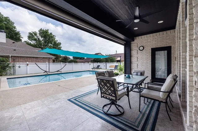 a view of a patio with table and chairs and potted plants