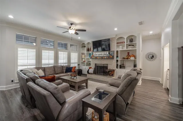 a living room with furniture fireplace and a window