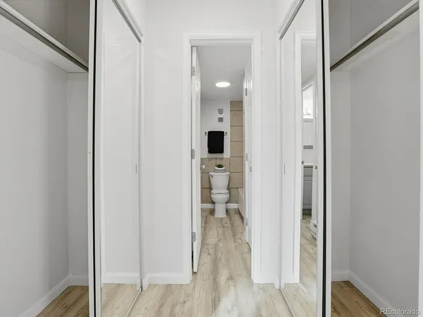 a view of a hallway with wooden floor and staircase