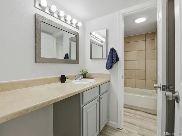 a bathroom with a sink a mirror and a bathtub