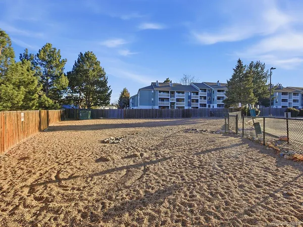 a view of a yard with a building in the background