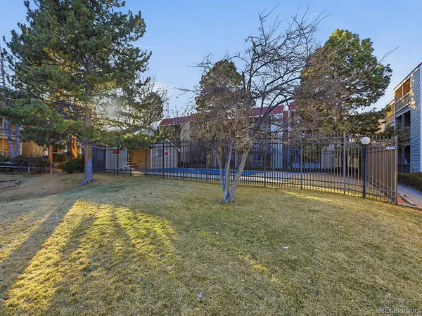 a swimming pool with outdoor seating and yard