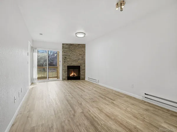 wooden floor fireplace and natural light in room