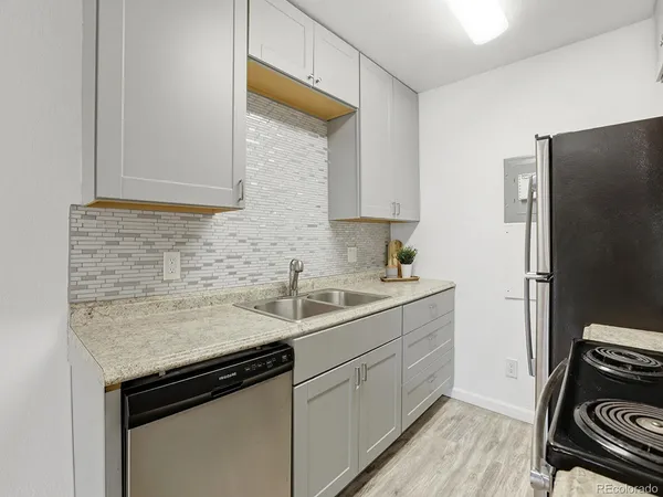 a kitchen with a sink stove and refrigerator