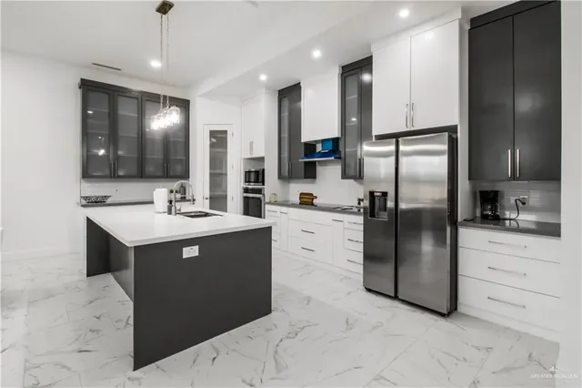 a kitchen with a refrigerator sink and cabinets
