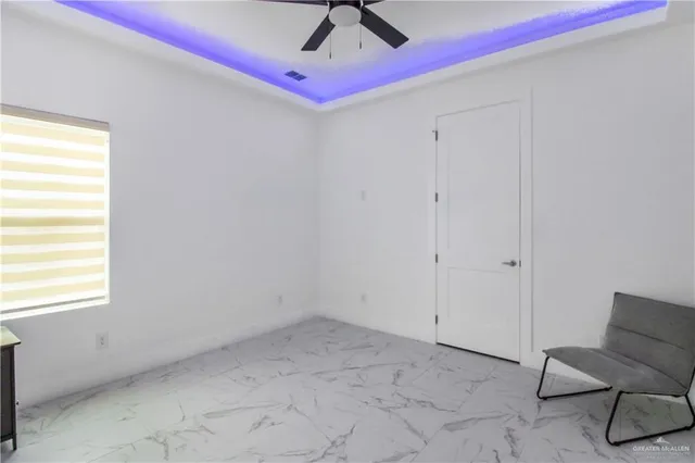 a view of room with window and ceiling fan