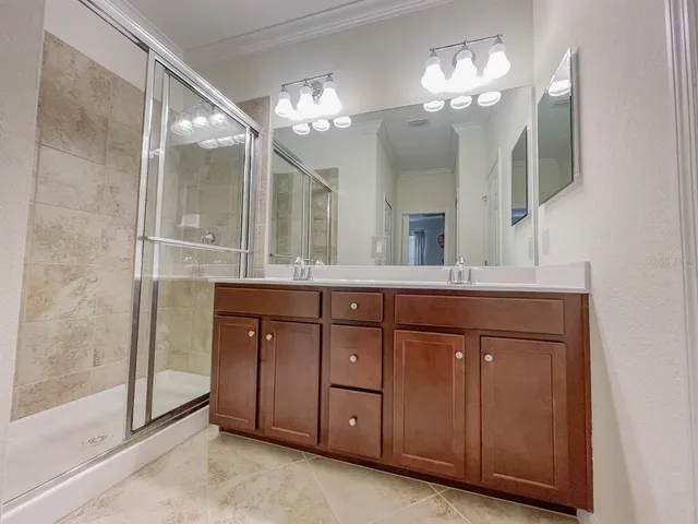 a view of an empty room with wooden floor and windows