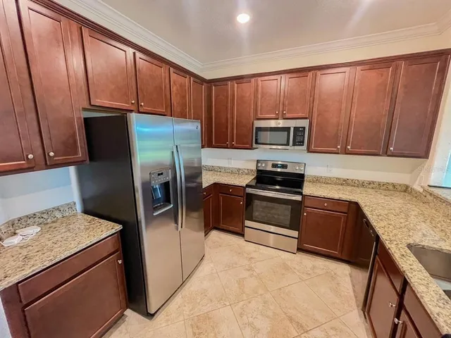 a kitchen with a refrigerator sink and stove