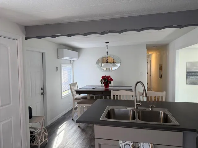 a kitchen with a sink and chandelier