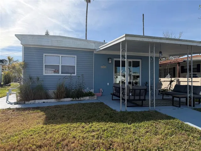 a view of a house with backyard porch and sitting area