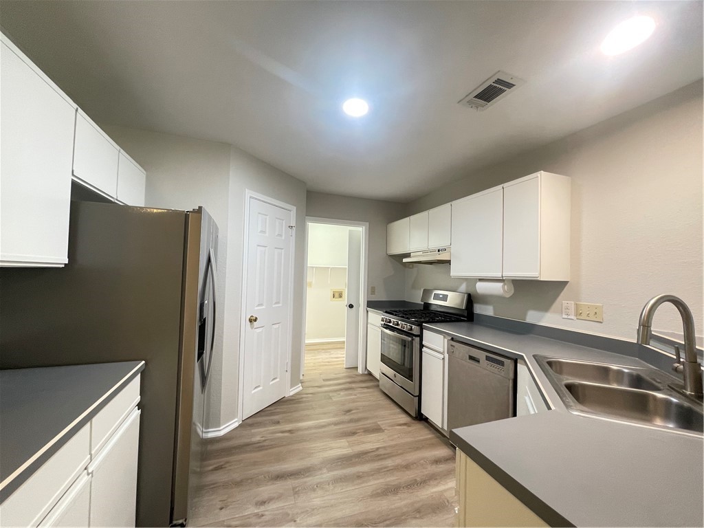 12333 Yarmont Way Austin, TX 78753 - Photo 17 of 40 a kitchen with stainless steel appliances granite countertop a sink stove and refrigerator