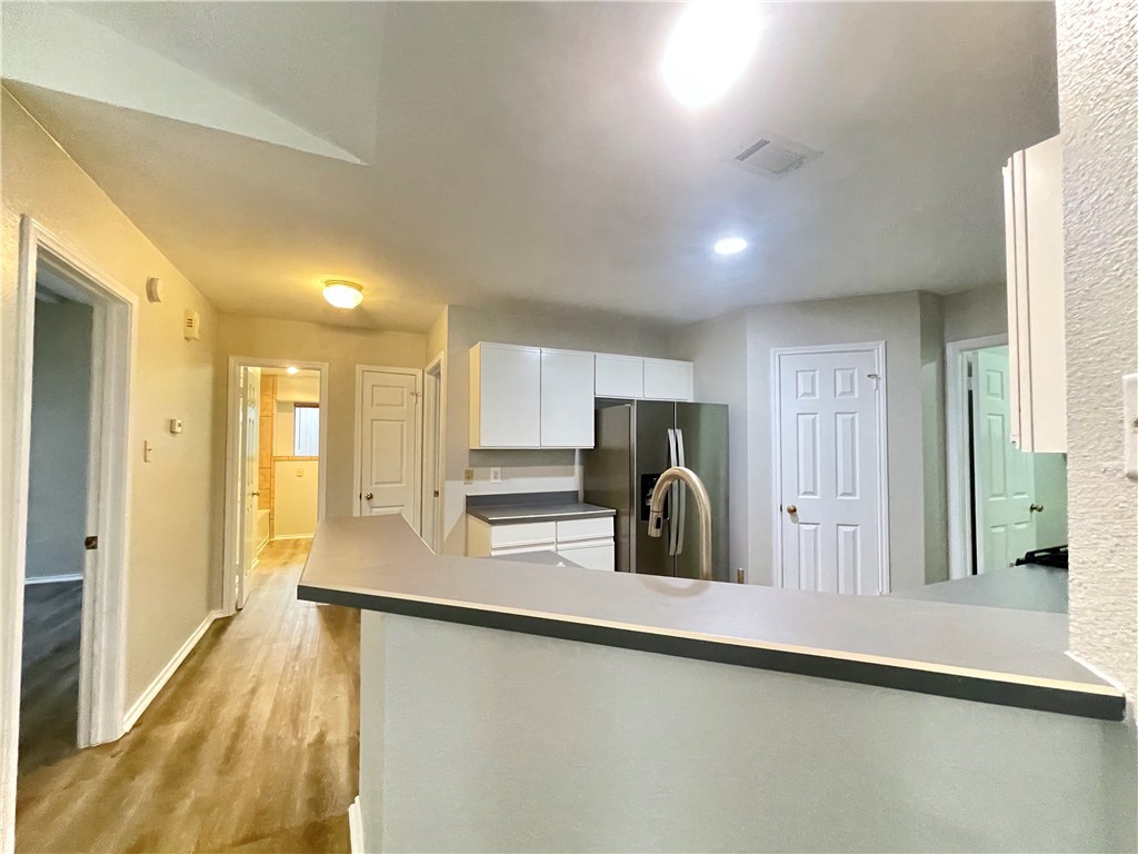 12333 Yarmont Way Austin, TX 78753 - Photo 19 of 40 a kitchen with stainless steel appliances granite countertop a sink a stove and a refrigerator