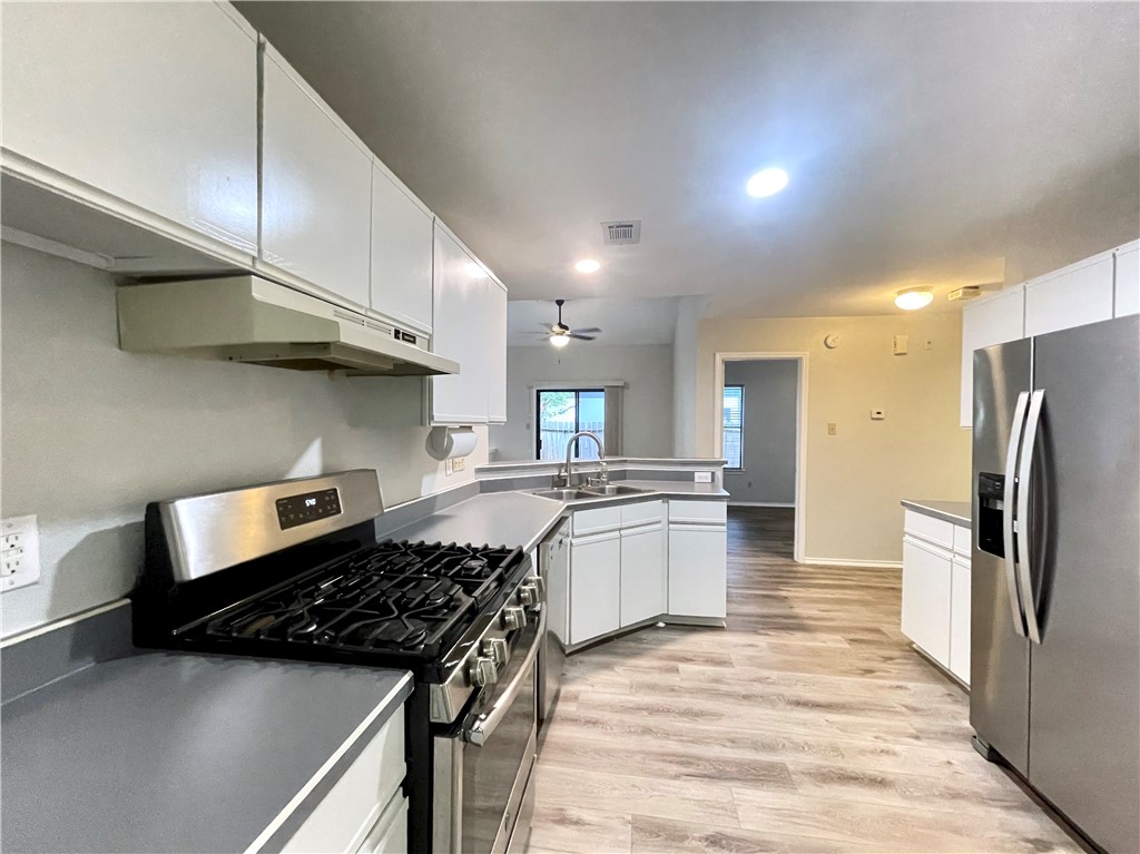 12333 Yarmont Way Austin, TX 78753 - Photo 20 of 40 a kitchen with stainless steel appliances granite countertop a sink stove and refrigerator