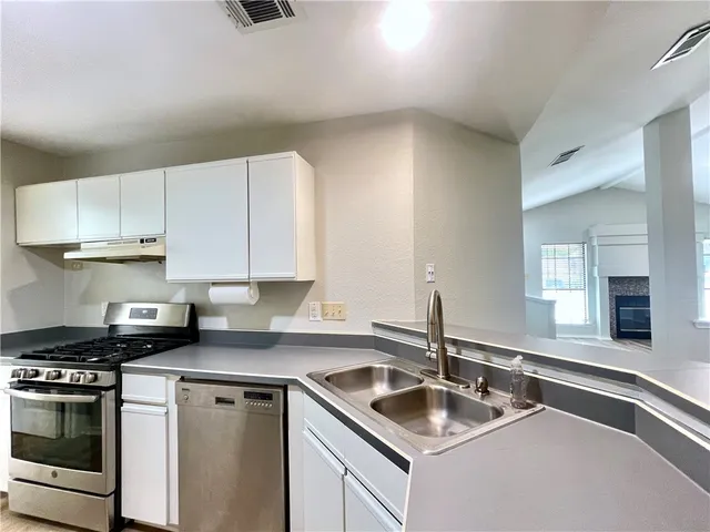 a kitchen that has a sink and a stove