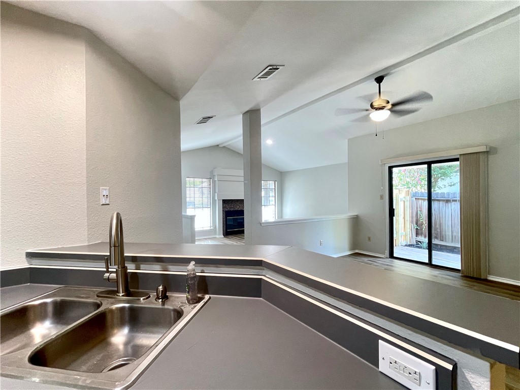 12333 Yarmont Way Austin, TX 78753 - Photo 22 of 40 a kitchen with a sink and a stove top oven