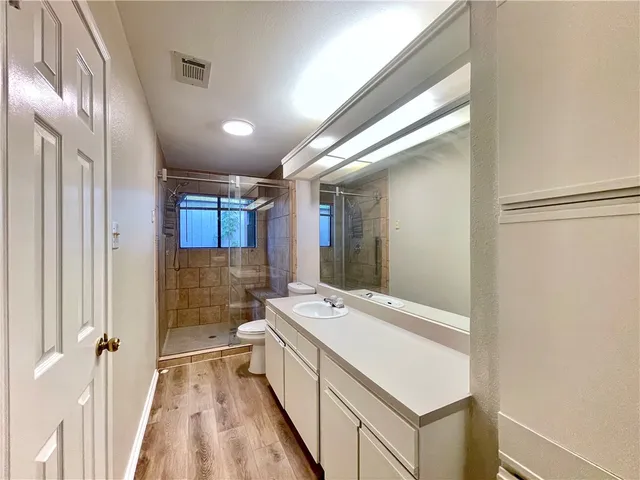 a bathroom with a sink a toilet and a mirror