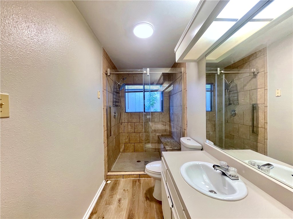 12333 Yarmont Way Austin, TX 78753 - Photo 29 of 40 a bathroom with a sink a toilet and shower