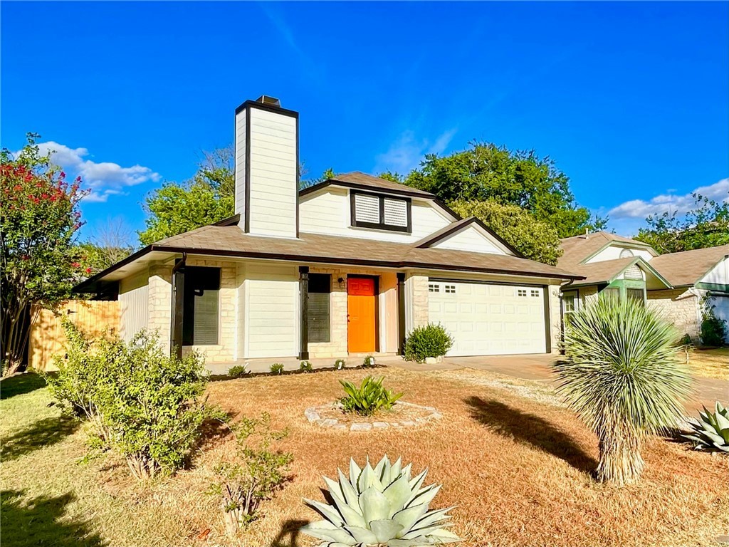 12333 Yarmont Way Austin, TX 78753 - Photo 3 of 40 a front view of a house with a yard