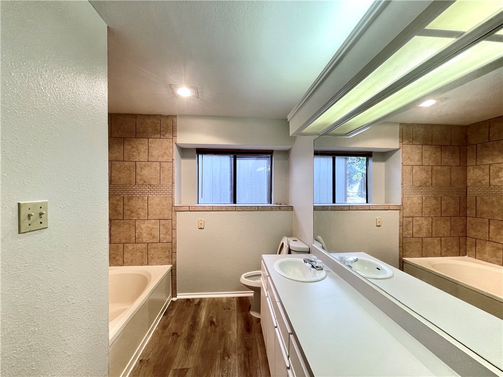 12333 Yarmont Way Austin, TX 78753 - Photo 35 of 40 a bathroom with a sink a bathtub and a shower