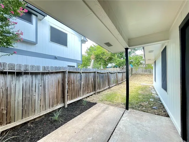 a view of a backyard with pathway