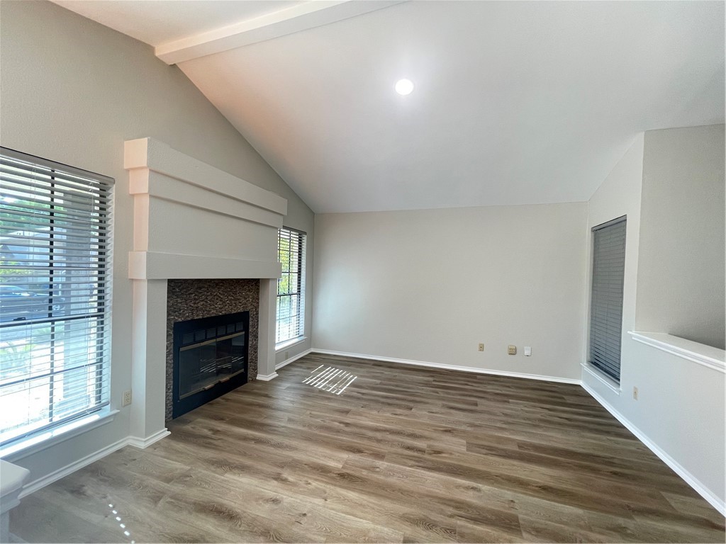 12333 Yarmont Way Austin, TX 78753 - Photo 9 of 40 a view of empty room with wooden floor and fireplace