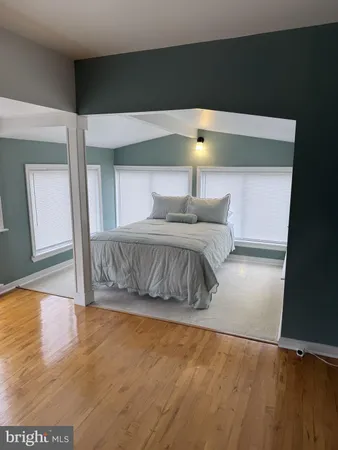a bedroom with a bed and a night stand