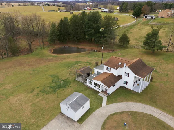 an aerial view of a house with a lake view