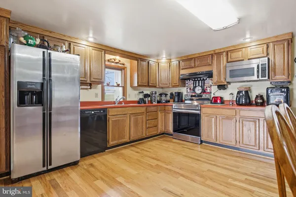a kitchen with a refrigerator a sink and a stove
