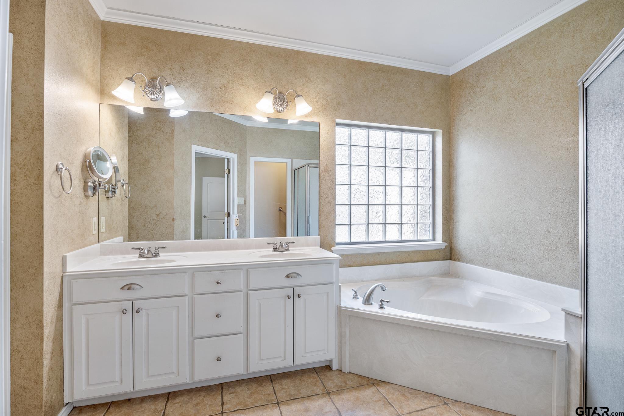 5603 Thomas Nelson Drive Tyler, TX 75707 - Photo 12 of 28 a spacious bathroom with a tub sink and mirror