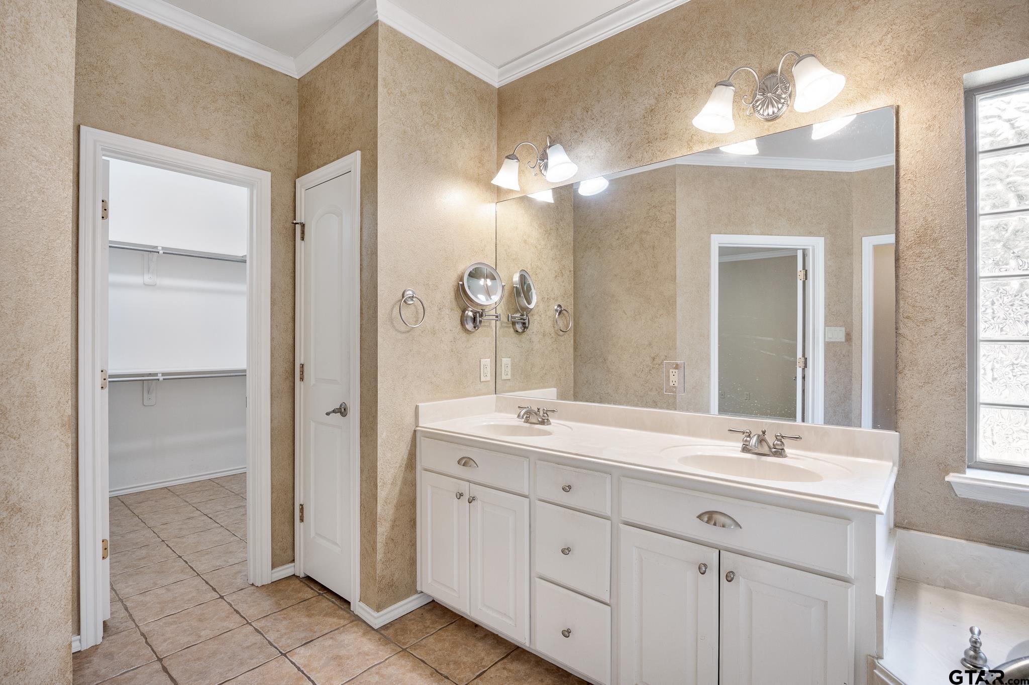 5603 Thomas Nelson Drive Tyler, TX 75707 - Photo 15 of 28 a bathroom with a double vanity sink and a mirror