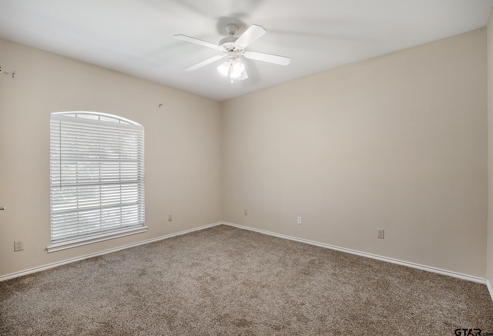 5603 Thomas Nelson Drive Tyler, TX 75707 - Photo 17 of 28 an empty room with windows and ceiling fan