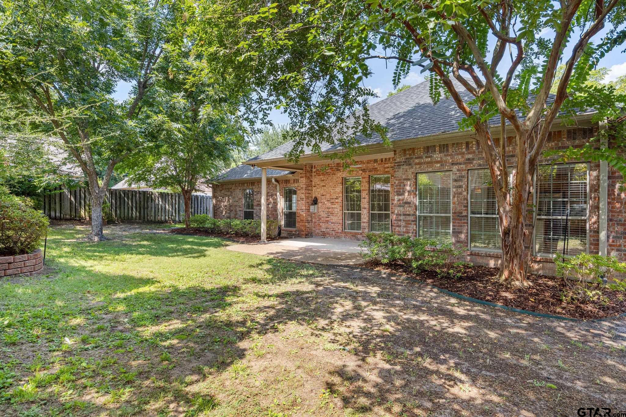 5603 Thomas Nelson Drive Tyler, TX 75707 - Photo 23 of 28 a view of a house with backyard and a tree