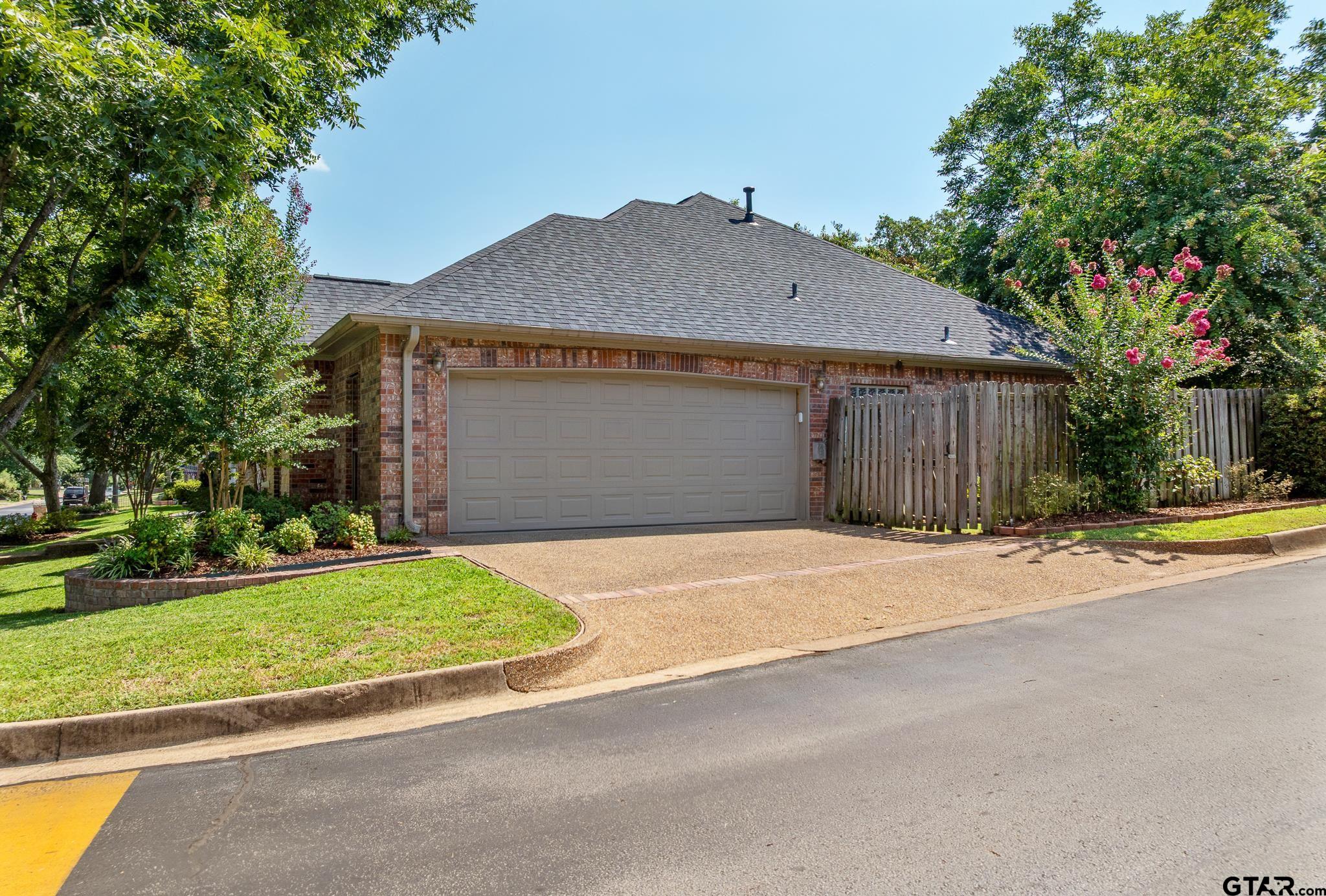 5603 Thomas Nelson Drive Tyler, TX 75707 - Photo 24 of 28 a front view of a house with a yard and garage