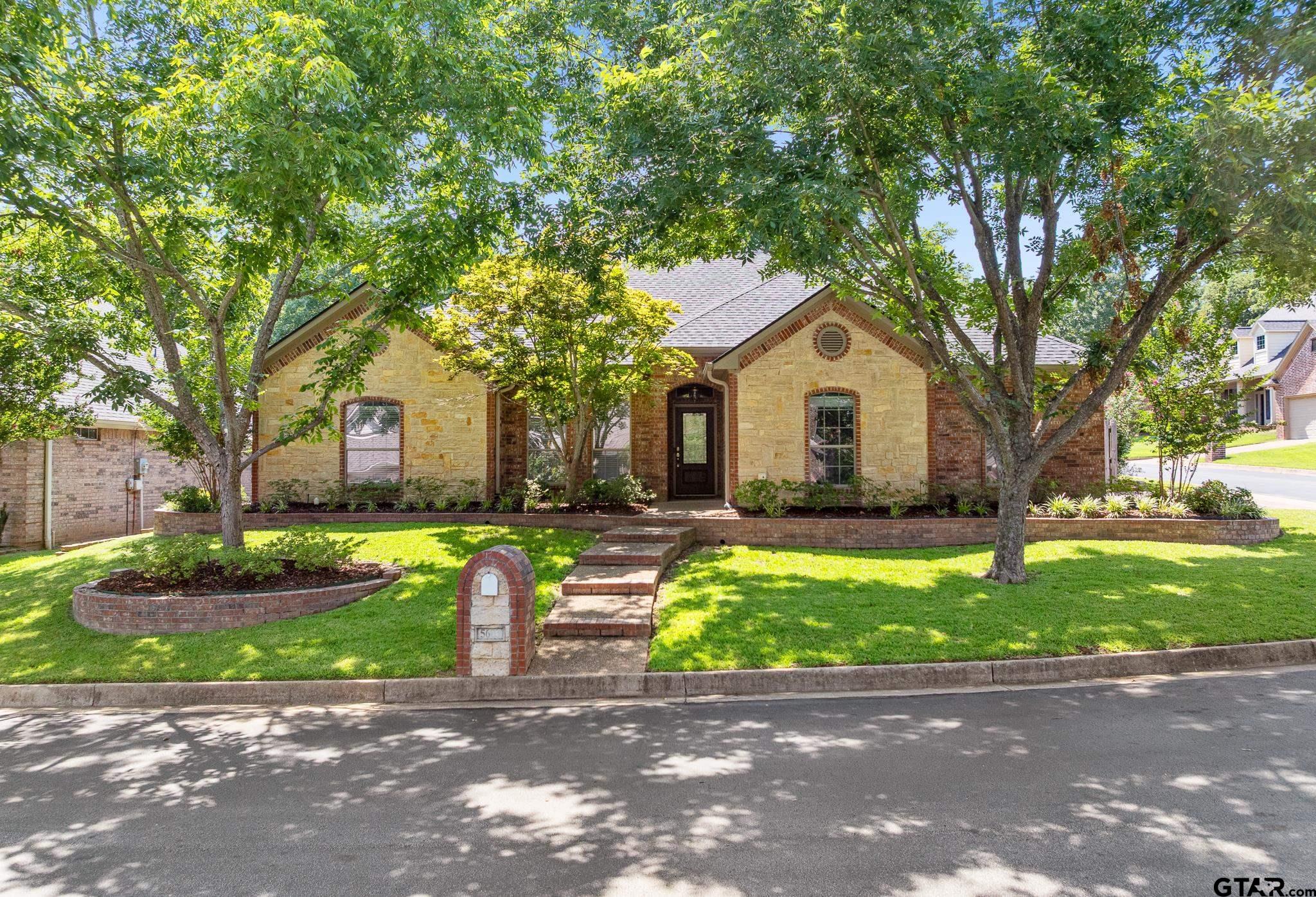 5603 Thomas Nelson Drive Tyler, TX 75707 - Photo 26 of 28 a front view of a house with a yard and garage