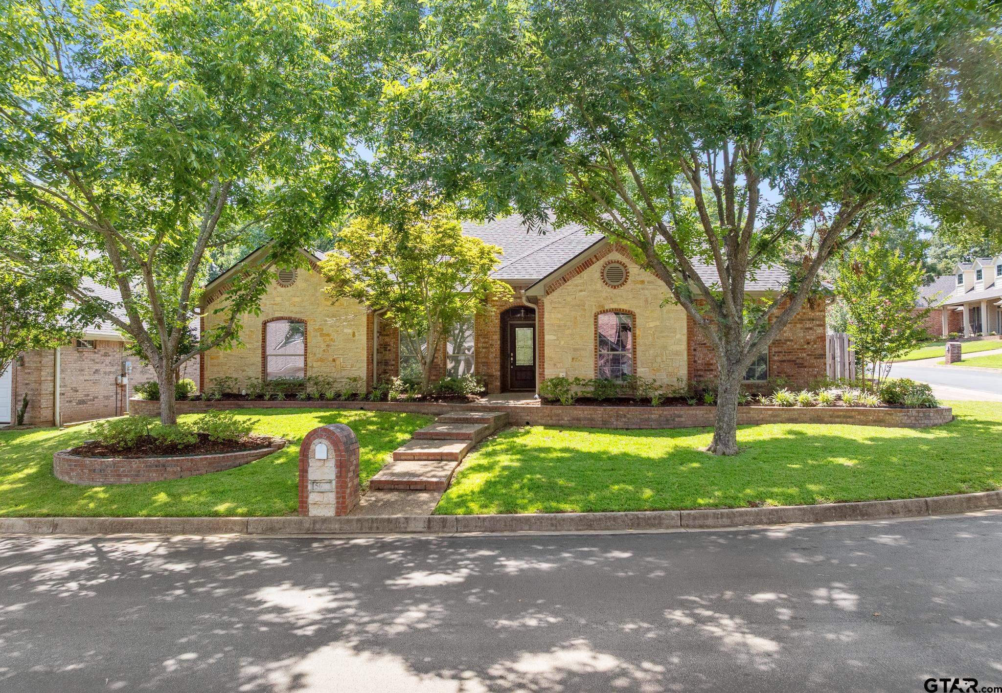 5603 Thomas Nelson Drive Tyler, TX 75707 - Photo 27 of 28 a front view of a house with a yard and garage