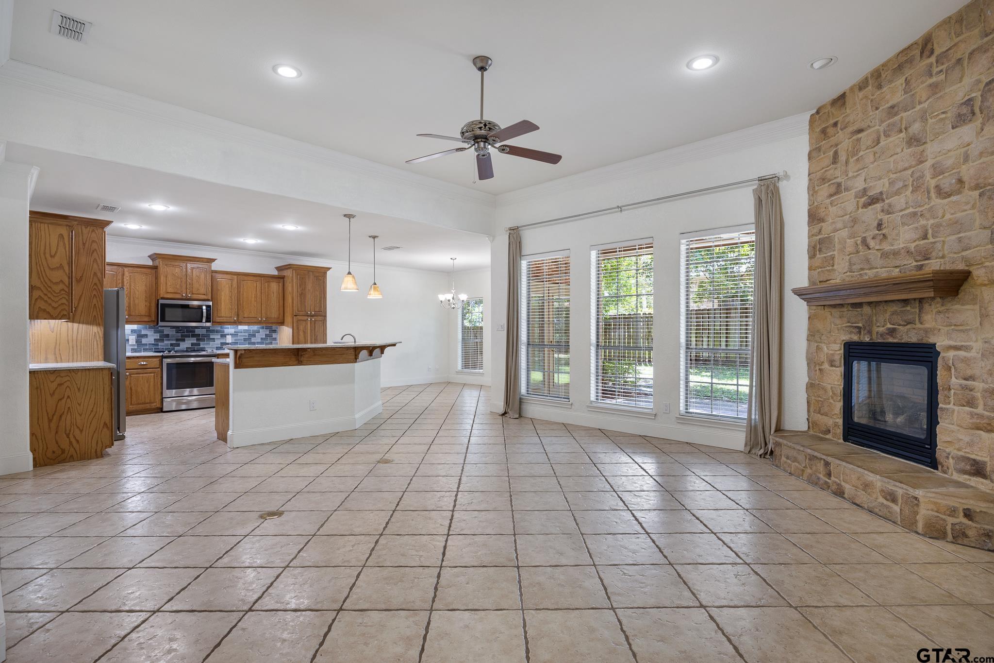 5603 Thomas Nelson Drive Tyler, TX 75707 - Photo 4 of 28 a view of a kitchen with furniture and a fireplace