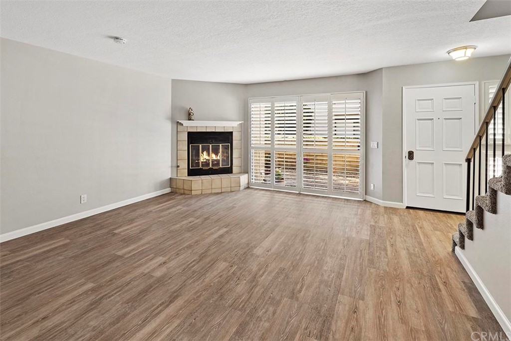 853 Swiss Trails Road Duarte, CA 91010 - Photo 1 of 1 an empty room with wooden floor and fireplace