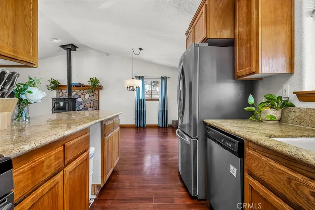 a kitchen with stainless steel appliances granite countertop a refrigerator and a sink