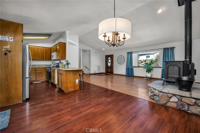 a view of kitchen and dining table with wooden floor
